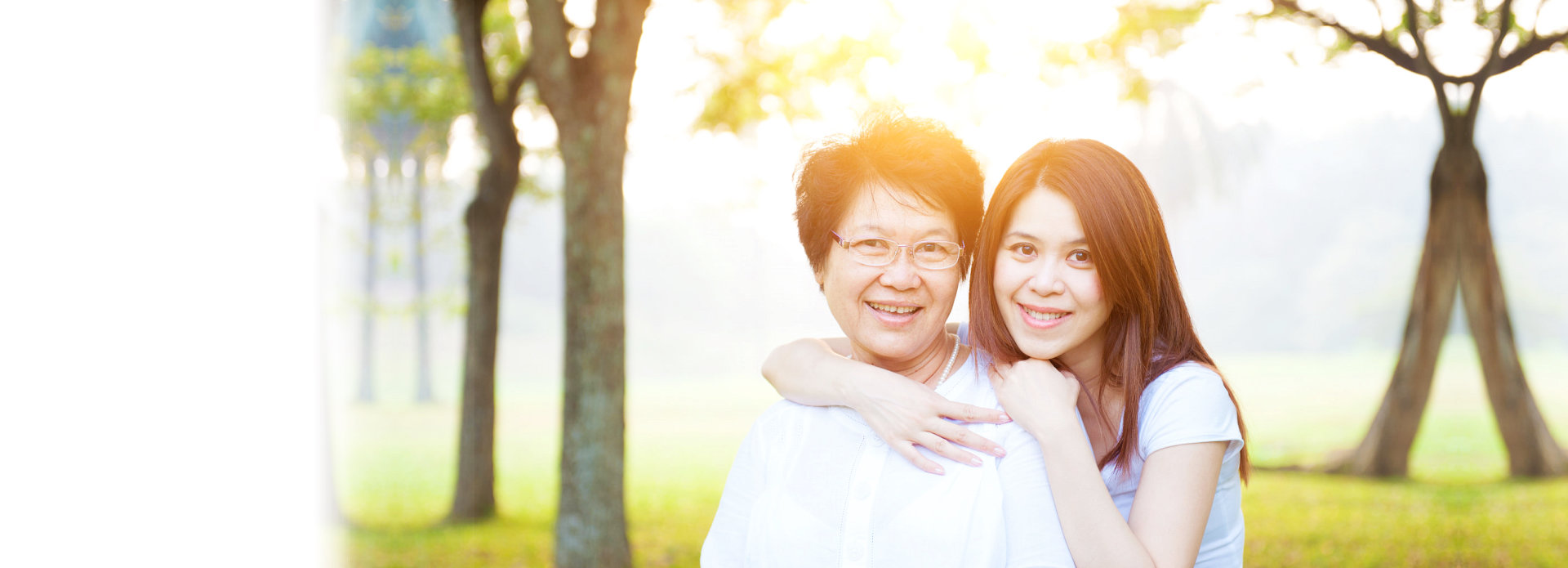 caregiver hugging elderly woman