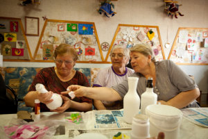 elderly people wrapping bottles